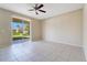 Bright room with tile flooring, ceiling fan, and sliding doors leading to a patio and backyard at 15107 Searobbin Dr, Lakewood Ranch, FL 34202