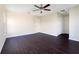 Spacious bedroom with dark vinyl floors and a ceiling fan at 15107 Searobbin Dr, Lakewood Ranch, FL 34202