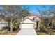 Charming two-story home with a well-manicured front yard, a spacious driveway, and an attached two-car garage at 15107 Searobbin Dr, Lakewood Ranch, FL 34202