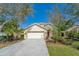 Charming single-Gathering home featuring a two-car garage, well-maintained landscaping, and a welcoming facade at 15107 Searobbin Dr, Lakewood Ranch, FL 34202