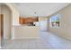 Open kitchen area with wooden cabinets and stainless steel appliances, seamlessly connected to the dining area at 15107 Searobbin Dr, Lakewood Ranch, FL 34202