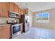 Well-lit kitchen featuring stainless steel appliances and a view of the backyard at 15107 Searobbin Dr, Lakewood Ranch, FL 34202