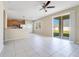 Open living area with a partial view of the kitchen and a sliding glass door to the backyard at 15107 Searobbin Dr, Lakewood Ranch, FL 34202