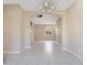 Open-concept living area with tile flooring, arched doorways, and neutral paint throughout at 15107 Searobbin Dr, Lakewood Ranch, FL 34202