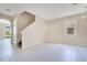 Bright living room with tile flooring, neutral walls, and a staircase leading to the upper level at 15107 Searobbin Dr, Lakewood Ranch, FL 34202