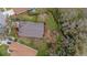 Aerial view of the home showcasing the landscaped yard, fenced backyard, and a serene outdoor seating area at 2727 Brookville Dr, Valrico, FL 33596