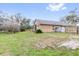 Expansive backyard with mature trees and a privacy fence provides ample space for outdoor activities at 2727 Brookville Dr, Valrico, FL 33596