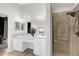 Bright bathroom boasts double sinks, vanity, and a modern glass-enclosed shower at 2727 Brookville Dr, Valrico, FL 33596