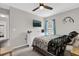 Neutral toned bedroom with a ceiling fan and window for natural light at 2727 Brookville Dr, Valrico, FL 33596