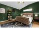 Bedroom with green walls, carpet flooring, a ceiling fan and a bed at 2727 Brookville Dr, Valrico, FL 33596