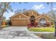 Charming single-story home with a well-manicured lawn, two car garage, and tasteful landscaping at 2727 Brookville Dr, Valrico, FL 33596