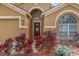 Charming front entrance with brick accents, a decorative door, and landscaped flower beds adding curb appeal at 2727 Brookville Dr, Valrico, FL 33596