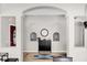 Elegant hallway with arched details, decorative niches, wood floors, and a stylish console table at 2727 Brookville Dr, Valrico, FL 33596