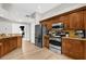 Well-equipped kitchen with stainless steel appliances, wooden cabinets, and wood floors at 2727 Brookville Dr, Valrico, FL 33596