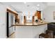 Open kitchen with stainless steel refrigerator, granite countertops and seating at the breakfast bar at 2727 Brookville Dr, Valrico, FL 33596