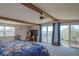 Bright bedroom with water views, natural beams, and sliding glass doors to the balcony at 373 Hile Ln, Punta Gorda, FL 33982