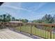 Wide wooden deck offers serene views of lush lawn and sparkling water at 373 Hile Ln, Punta Gorda, FL 33982