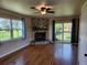 Inviting living room with a stone fireplace, large windows, and sliding door access at 373 Hile Ln, Punta Gorda, FL 33982