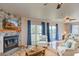 Bright living room features a stone fireplace and access to the outdoor space through sliding glass doors at 373 Hile Ln, Punta Gorda, FL 33982