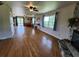 Spacious living room with hardwood floors, a stone fireplace, and scenic outdoor views at 373 Hile Ln, Punta Gorda, FL 33982