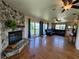 Spacious living room with a stone fireplace, hardwood floors, and plenty of natural light at 373 Hile Ln, Punta Gorda, FL 33982