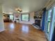 Bright living room featuring hardwood floors, stone fireplace, and access to the outdoor deck at 373 Hile Ln, Punta Gorda, FL 33982