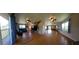 Open-concept living room with hardwood floors, ceiling fans, and staircase to upper level at 373 Hile Ln, Punta Gorda, FL 33982