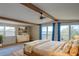 Spacious main bedroom with a large bed, exposed beams, and sliding doors to a balcony at 373 Hile Ln, Punta Gorda, FL 33982