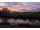 Picturesque water view at dusk with a quaint dock and vibrant sky colors at 373 Hile Ln, Punta Gorda, FL 33982