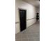 A black entry door with decorative trim and tiled flooring at 501 Knights Run Ave # 2106, Tampa, FL 33602