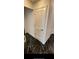 Hallway with black marble floors and a white louvered door at 501 Knights Run Ave # 2106, Tampa, FL 33602