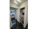 Hallway with black marble floors leading to a bathroom with double sinks at 501 Knights Run Ave # 2106, Tampa, FL 33602
