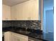 Kitchen featuring updated cabinets, countertops, backsplash, and stainless steel appliances at 501 Knights Run Ave # 2106, Tampa, FL 33602