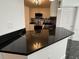 Eat in kitchen with modern appliances and sleek black countertops at 501 Knights Run Ave # 2106, Tampa, FL 33602
