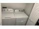 Convenient laundry area with modern washer and dryer units, and white walls at 501 Knights Run Ave # 2106, Tampa, FL 33602