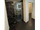 Sleek black marble shower with glass door and black hexagon tile in modern bathroom at 501 Knights Run Ave # 2106, Tampa, FL 33602