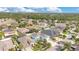 High-angle view of a Gathering-friendly neighborhood with landscaped yards, mature trees, and houses, creating a welcoming atmosphere at 7108 Harvest Glen Ln, Riverview, FL 33578