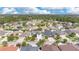 Aerial shot showing the community's well-maintained streets, homes, and lush landscaping, set against a backdrop of mature trees and sky at 7108 Harvest Glen Ln, Riverview, FL 33578