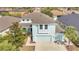 Aerial view of a well-maintained two-story home with a three-car garage and mature landscaping at 7108 Harvest Glen Ln, Riverview, FL 33578