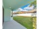 Expansive backyard featuring a well-maintained lawn and privacy fence with a covered patio at 7108 Harvest Glen Ln, Riverview, FL 33578