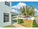 Picture of a large green backyard featuring mature trees, lush grass, and a covered patio at 7108 Harvest Glen Ln, Riverview, FL 33578