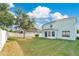 Spacious backyard with a well-manicured lawn, large perimeter privacy fence, and an outdoor living space at 7108 Harvest Glen Ln, Riverview, FL 33578