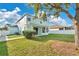 A well-maintained backyard featuring green lawn and landscaping with a sidewalk and privacy fence at 7108 Harvest Glen Ln, Riverview, FL 33578