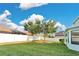 Picture of a lush backyard, showing the large green lawn, trees, and white perimeter fence at 7108 Harvest Glen Ln, Riverview, FL 33578