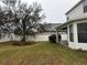 Spacious backyard enclosed with a white vinyl fence and mature tree at 7108 Harvest Glen Ln, Riverview, FL 33578