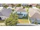 Aerial view of a well-maintained backyard with a white fence, lush grass, and an enclosed porch, offering a private outdoor space at 7108 Harvest Glen Ln, Riverview, FL 33578