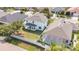 Aerial view of a backyard showcasing a white fence, manicured lawn, and a screened-in pool, ideal for relaxation and outdoor entertainment at 7108 Harvest Glen Ln, Riverview, FL 33578