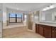 Luxurious bathroom with a soaking tub, glass-enclosed shower, and granite vanity at 7108 Harvest Glen Ln, Riverview, FL 33578