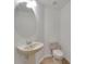 Half bathroom with a pedestal sink, oval mirror, and modern fixtures at 7108 Harvest Glen Ln, Riverview, FL 33578