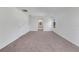 Large bedroom featuring neutral carpet, an arched entry and bright, natural light at 7108 Harvest Glen Ln, Riverview, FL 33578